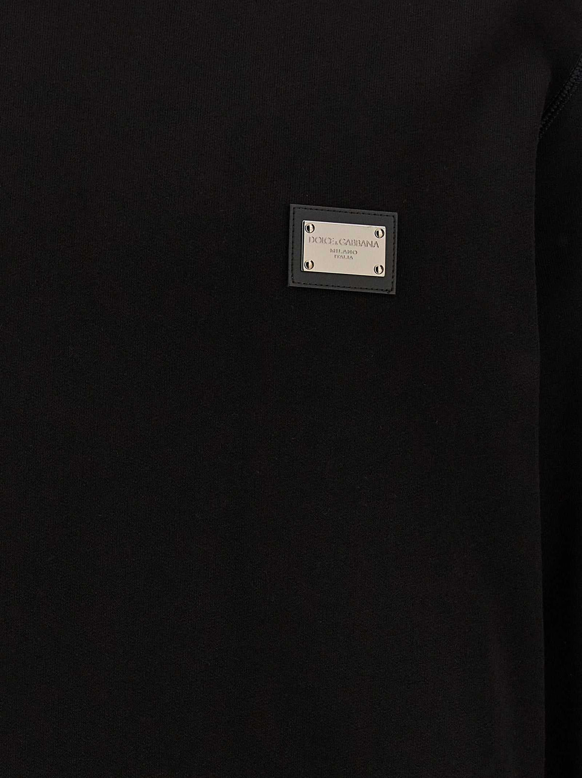 Dolce & Gabbana schwarzer Baumwoll-Sweatshirt mit Lederpatch und Logo-Tags